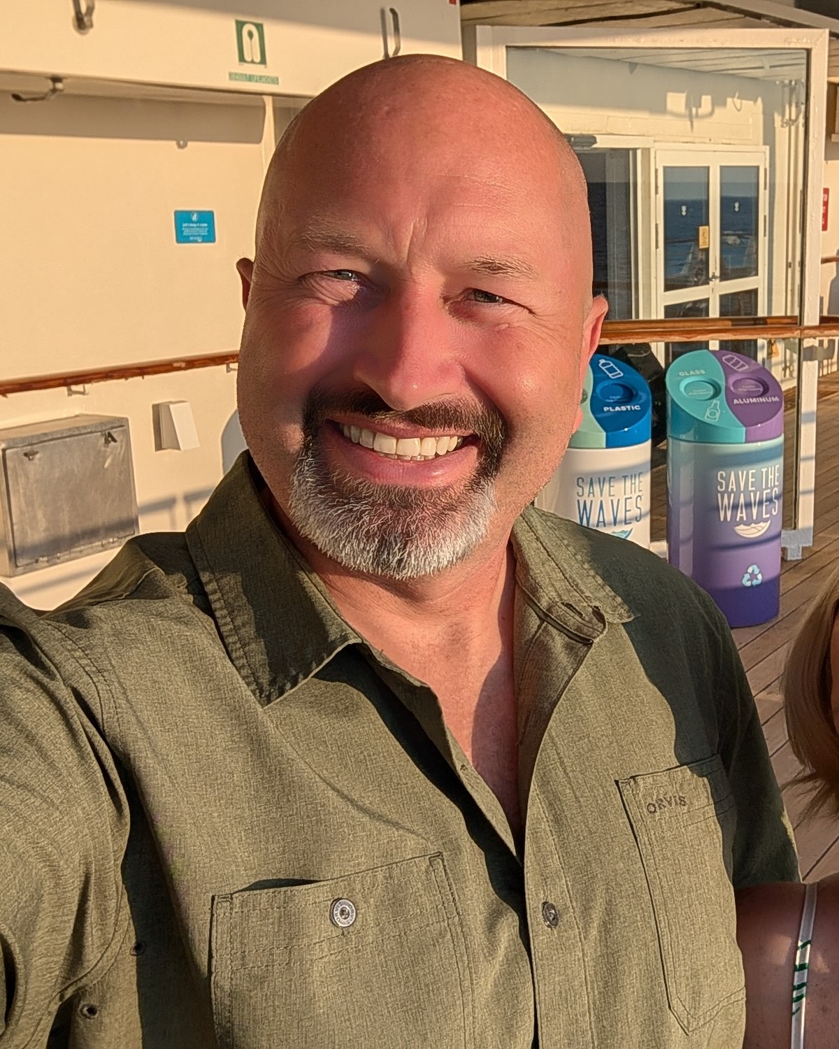 Ryan Halford smiling on a Royal Caribbean promenade deck at golden hour